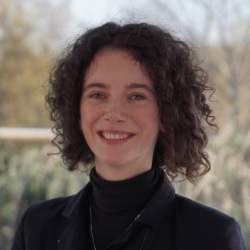 A portrait of a young woman smiling towards the camera
