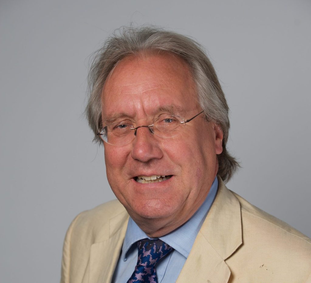Portrait of a man in glasses looking towards the camera.