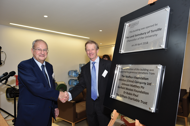 Two men in suits shake hands. A plaque behind them commemorates the formal opening of the new Department of Chemical Engineering and Biotechnology building