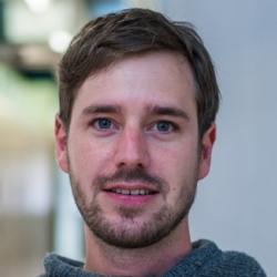A portrait of a man looking towards the camera