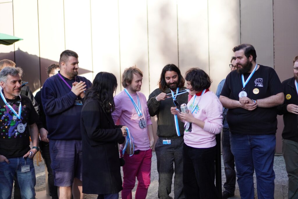 Group of people with medals looking happy at RObot Club tournament, outside CEB.